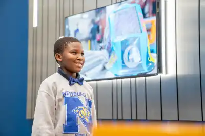 Young boy smiling for a picture for his future college id.